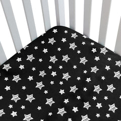 Moonsea Black Star crib sheet side view demonstrates snug fit for a standard crib
