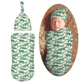 Muishi watercolor crocodiles swaddle blanket open, cozy newborn wrap.