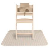 Mushie Baby Splat Mat under high chair protects surfaces during meals