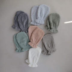 Mushie elastic-cuff mitt on hand, secure fit during bath