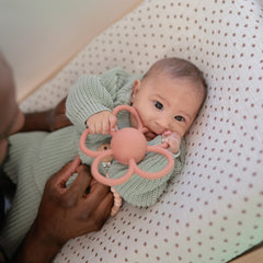 Mushie Daisy Rattle grip handle designed for tiny hands.