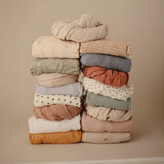 Mushie crib sheet with deep pockets for secure mattress fit.