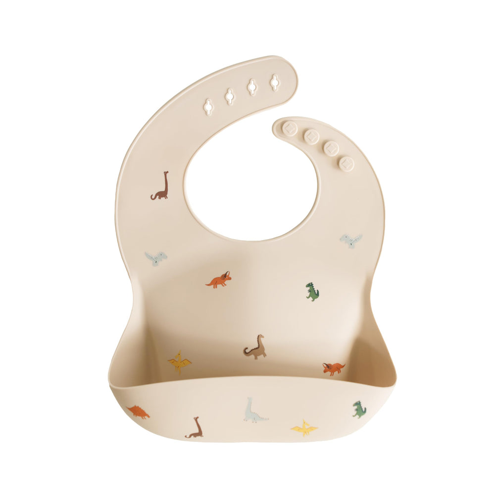 Mushie dinosaur bib with adjustable neck for a snug, comfortable fit during meals.