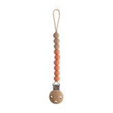 Mushie Eva clip beads closeup shows durable, BPA-free silicone for on-the-go soothing items.