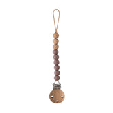Mushie Eva pacifier clip closure with secure silicone clasp for on-the-go safety.