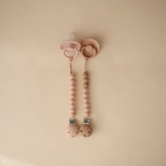 Mushie Eva pacifier clip molded clasp for easy attachment.