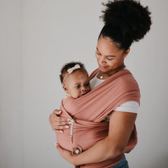 Mushie Eva Sage clip attached to baby clothing for easy access