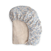 Mushie extra soft muslin fitted crib sheet in blue flowers for breathable baby comfort.