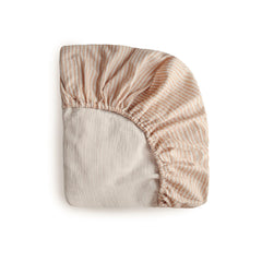 Mushie extra soft muslin fitted mini crib sheet in natural stripe for cozy, breathable nights.