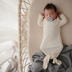 Mushie fitted mini crib sheet with full elastic edge for secure fit.