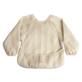 Mushie long sleeve bib front view in retro stripes protects outfits during meals