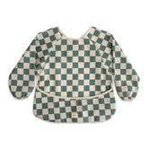 Mushie long sleeve bib Olive Check closeup shows water-resistant fabric for messier moments