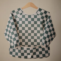 Mushie long sleeve bib Olive Check on a toddler during a meal