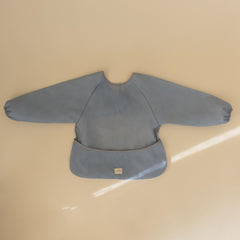 Mushie Tradewinds bib with Velcro closure eases on and off.