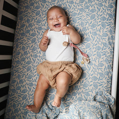 Mushie Muslin Swaddle Blanket blue flowers baby swaddle for soothing sleep moments.