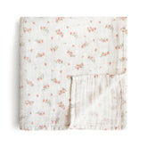 Mushie muslin swaddle blanket in pink flowers offers breathable warmth and cozy coverage