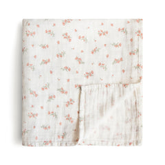 Mushie muslin swaddle blanket in pink flowers offers breathable warmth and cozy coverage