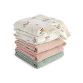 Mushie muslin washcloths with pink flowers design for gentle bath cleansing.