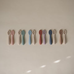 Mushie spoons feature sensory dots to soothe teething gums during meals.