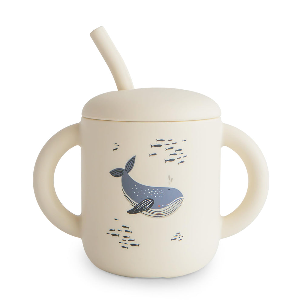 Mushie Whales training cup with lid helps prevent spills.