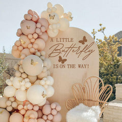 MUWEOL A Little Butterfly Is On The Way decal on wall adds charming baby shower ambience.