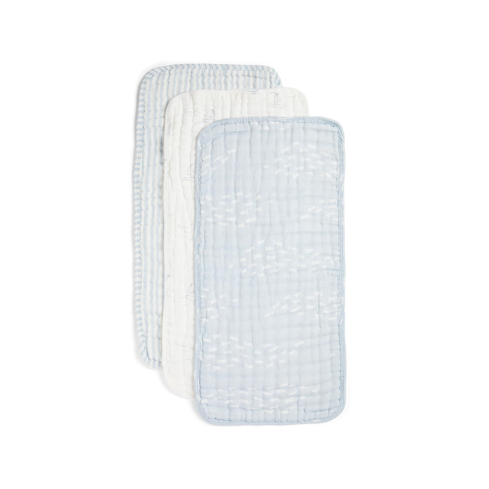 Nana Baby Organics burp cloths folded in powder blue and cream for soft skin protection.