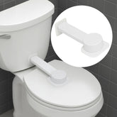 NANZO toilet lock on a flat lid showing secure adhesive base.