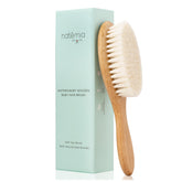 Natemia wooden baby hair brush with soft goat bristles for gentle scalp care.