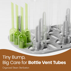 NCVI steamer tray closeup highlights replaceable bottle trays for versatile bottle sizes.