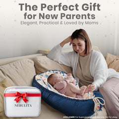 Nebulita newborn lounger blue with foldable base for flexible bottle-feeding positions.