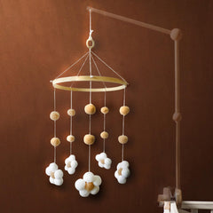 Nerdichic daisy flower mobile on wood hoop ideal for soothing newborns in a neutral nursery.