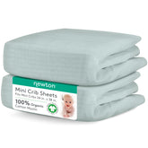 Newton Baby sage mini crib sheets close-up highlighting breathable organic muslin for baby comfort.