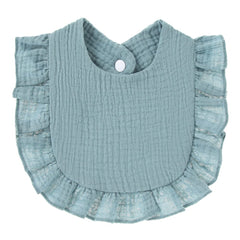 Baby wearing Nishine blue bib during feeding with clean outfit