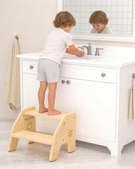 NMEO toddler step stool in wooden two-step design provides sink access and stability.