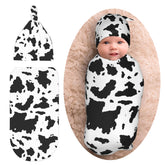 Norchzi cow print swaddle with hat set keeps baby snug and secure.