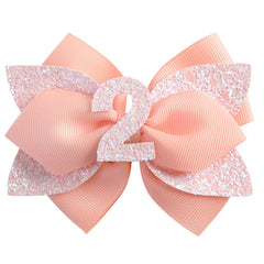 Nuolich glitter birthday bow peach adds festive sparkle to toddler hairstyles.