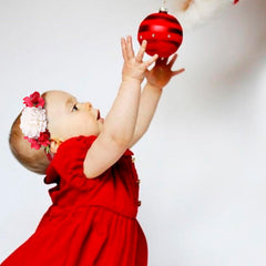 NUWAJP baby girl headband worn with Christmas outfit highlights chic floral bow detail.