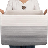 OIAHOMY rectangular cotton rope basket for blanket storage in living room.