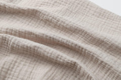Onacosht muslin sheets in fog and beige offer soft, breathable cotton comfort.