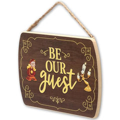 Disney Beauty and the Beast Be Our Guest sign on wood adds playful nostalgia to a guest room.
