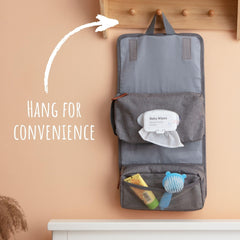 Outbound Basics diaper pouch hanging from restroom hook for convenient diaper changes