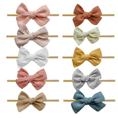 Ovenot Baby Bow Headband cream color, soft on delicate skin and gentle for newborns.