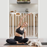 Owlie baby gate with adjustable width on stairs for child safety.