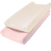 Owlowla changing pad cover with pink-cream minky dots offers a soft, cozy surface.