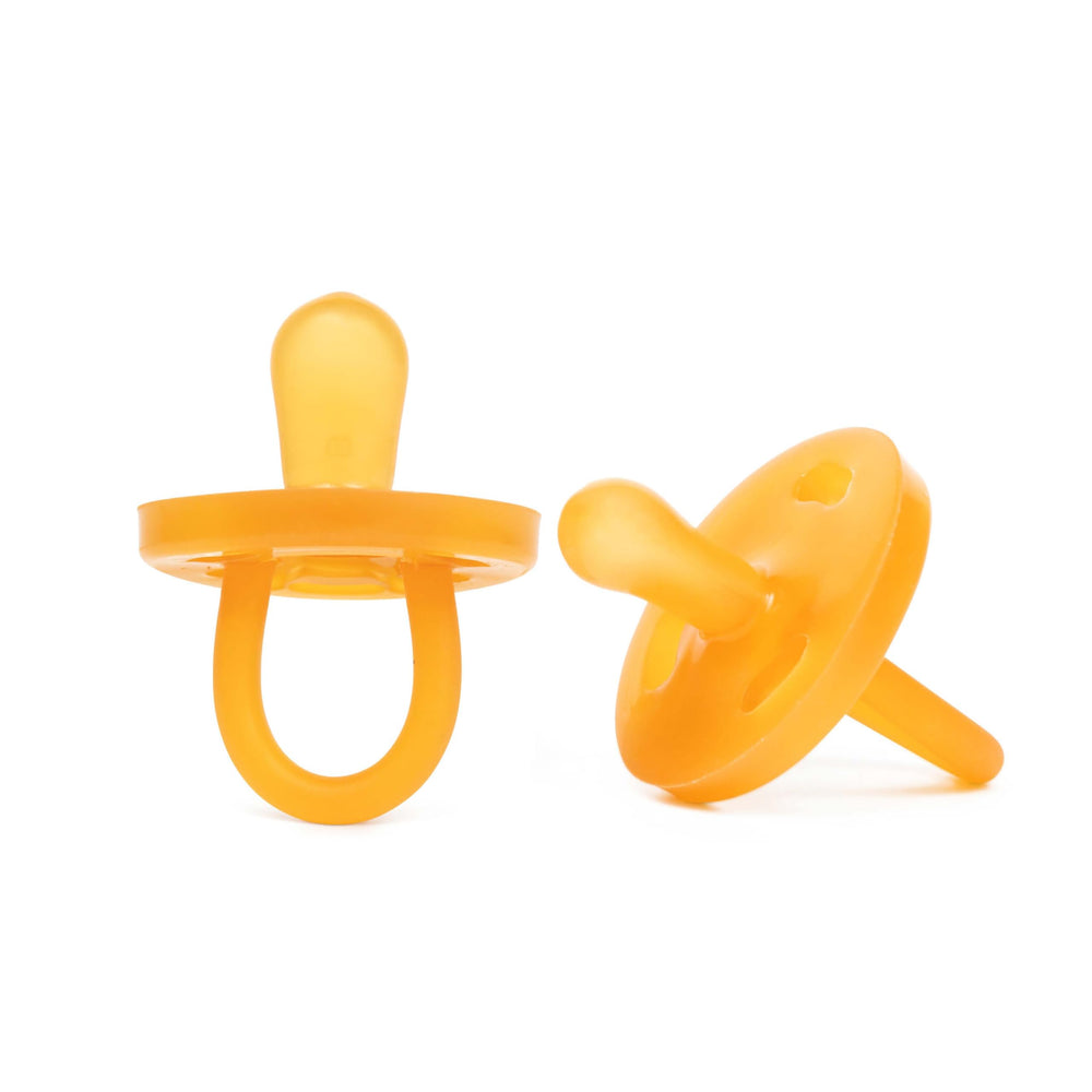 PaciBamber amber oil pacifier close-up for gentle gum soothing with natural rubber.