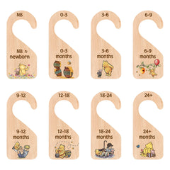 PAMBO Winnie Bear closet divider organizes baby outfits in a tidy nursery.