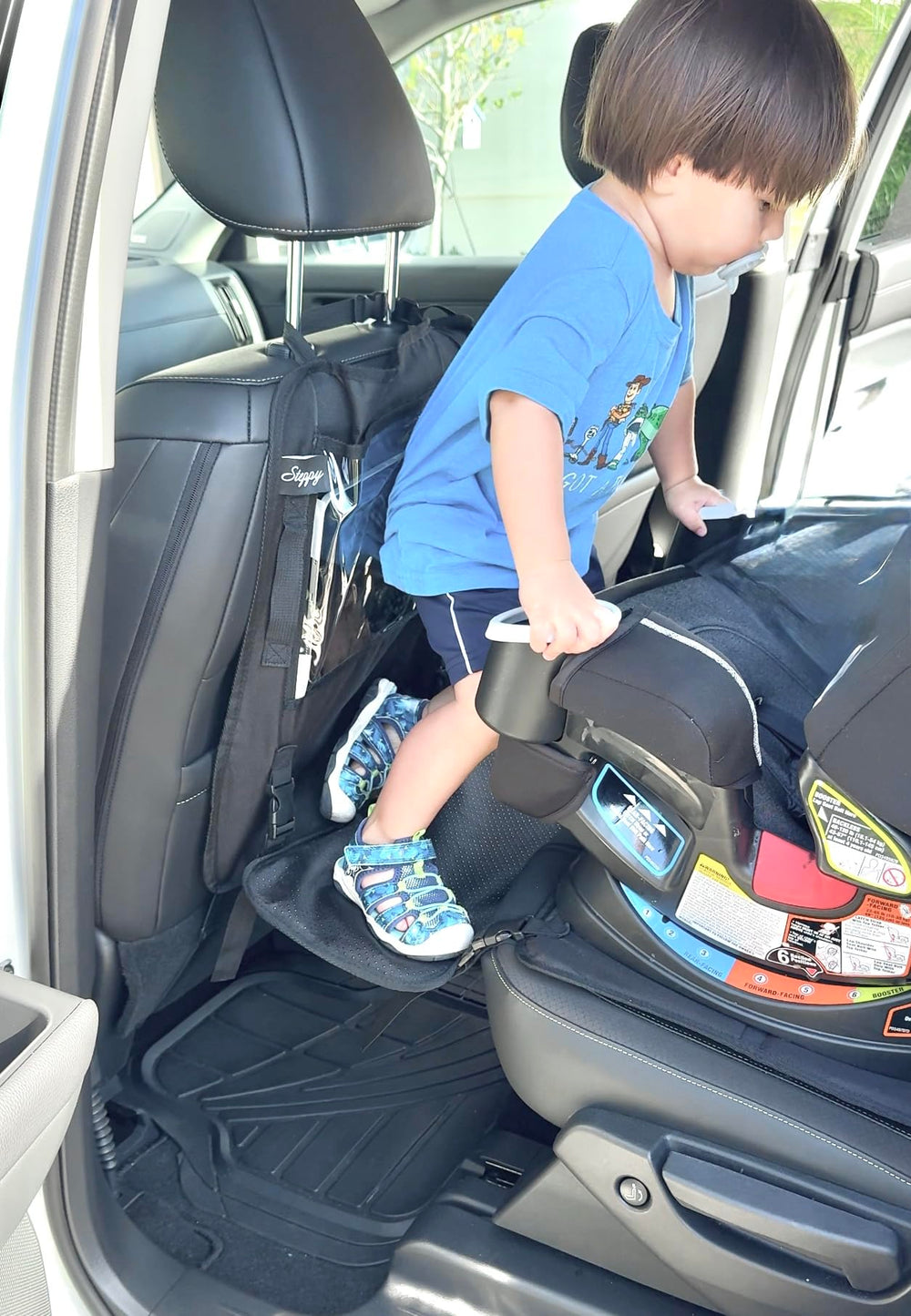 Peace of Mind Steppy car-seat access step helping a child climb into a parked car seat