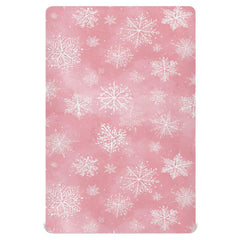 Pfrewn Christmas crib sheet with pink retro snowflakes on a mini crib for cozy naps