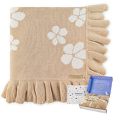 Pinuotu cotton baby blanket with ruffled edges provides gentle warmth and comfort.