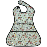 Plie full coverage bib with bear print worn by toddler during mealtime for mess protection.